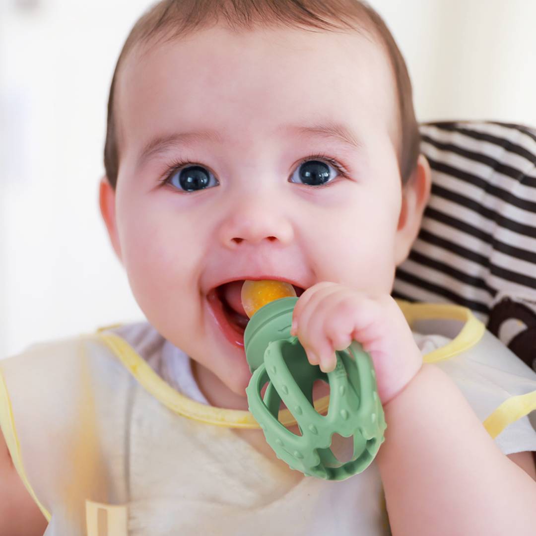 Baby eating solid food using the Haakaa Octopus Fresh Food Feeder